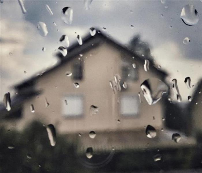 Blurry house through a rainy window