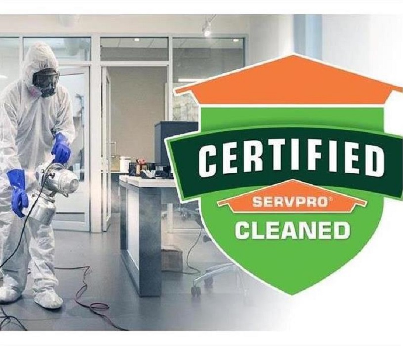 SERVPRO technician in PPE, cleaning commercial business 